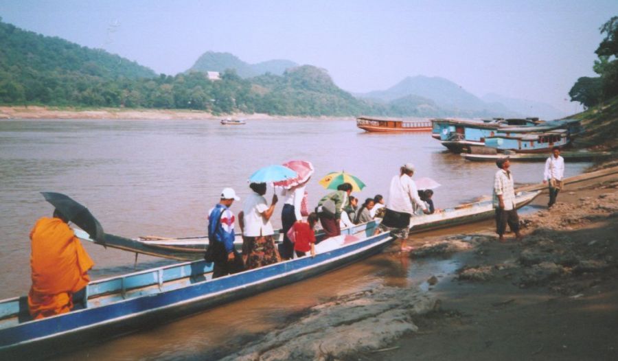Foot passengers disembarking from ferry on Mekong River at Luang Prabang